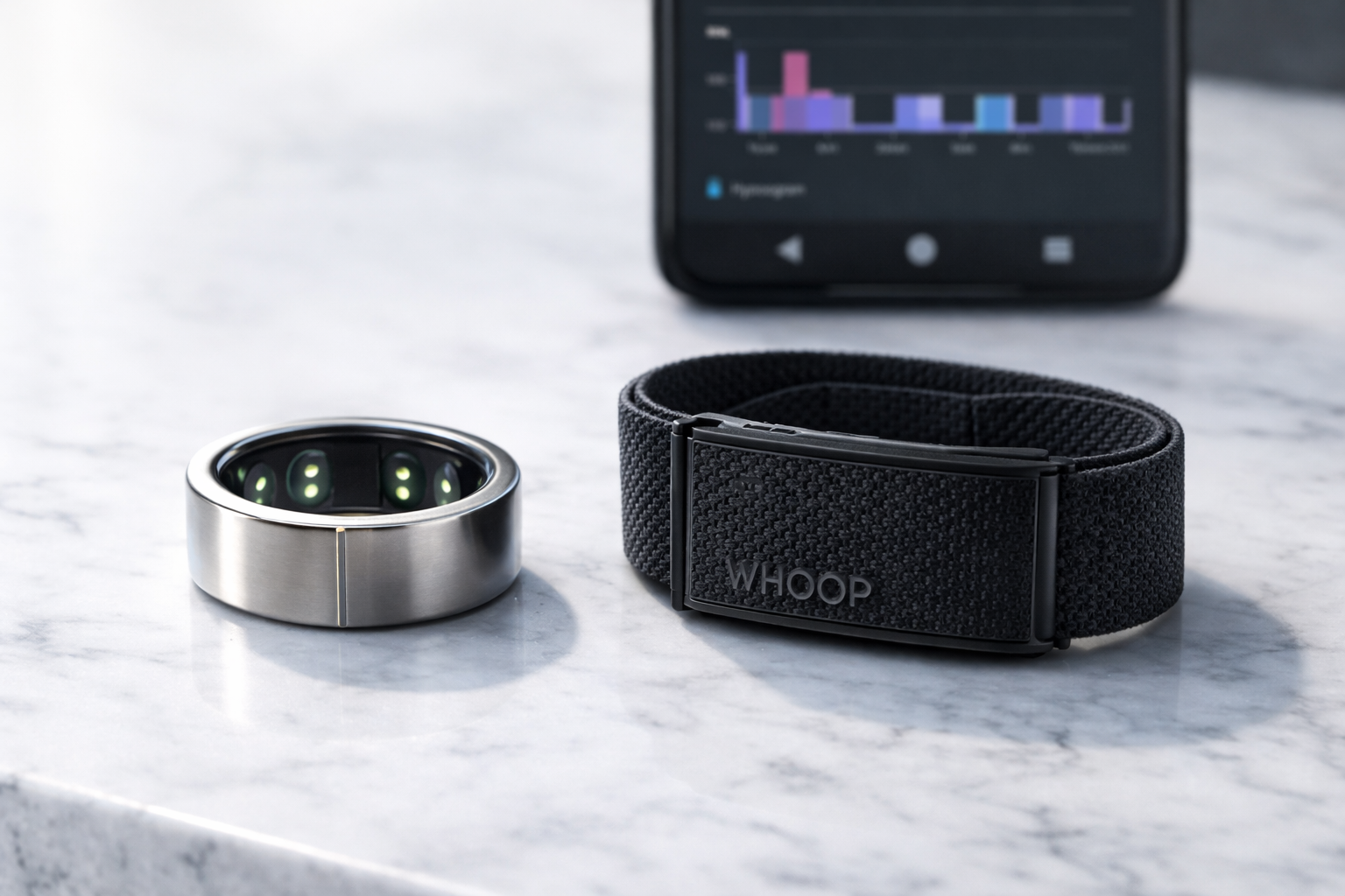Comparison of Oura Ring 4 and WHOOP 5.0 sleep tracking devices on a minimalist desk